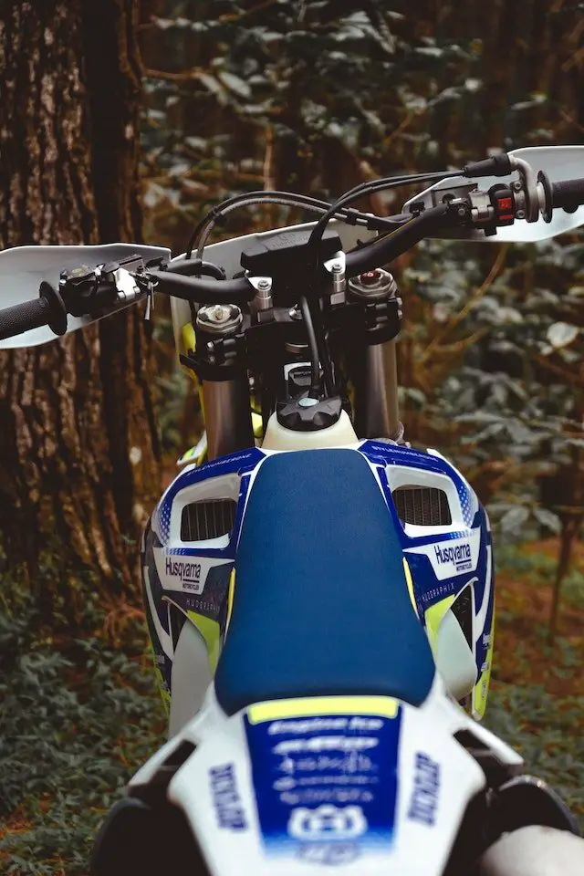 blue dirt bike in the forest