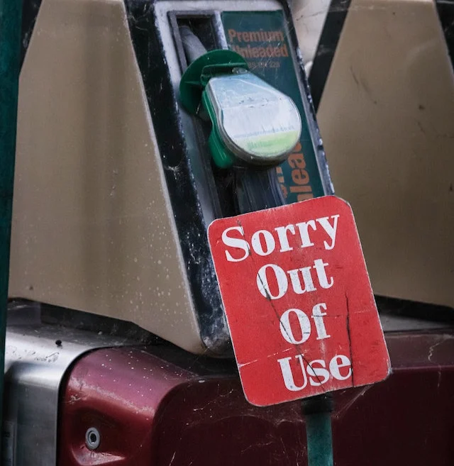 red signage on fuel pump