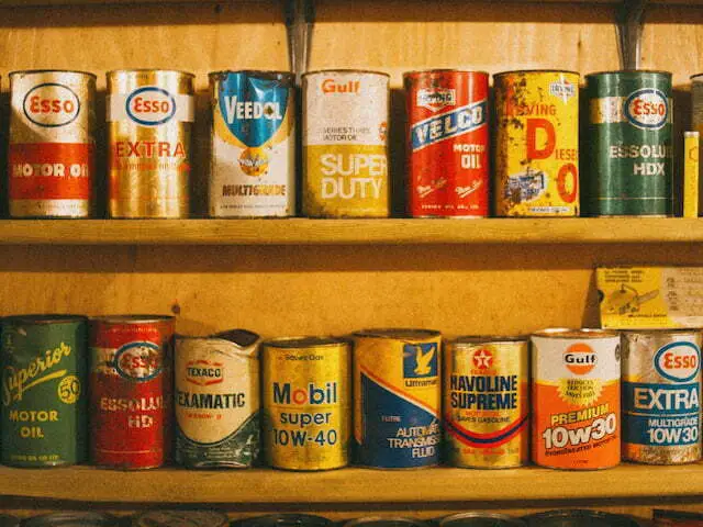 assorted-oil-cans-on-wooden-shelves