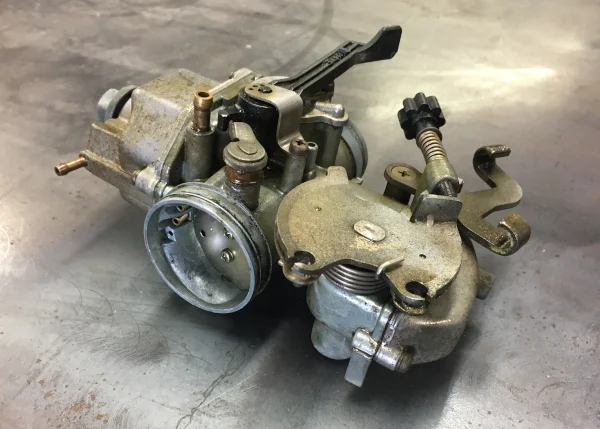 dirt bike carburetor on metal table