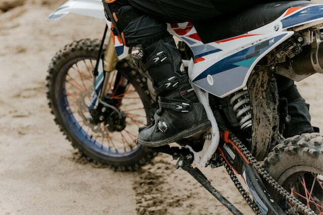 person wearing dirt bike boots close up