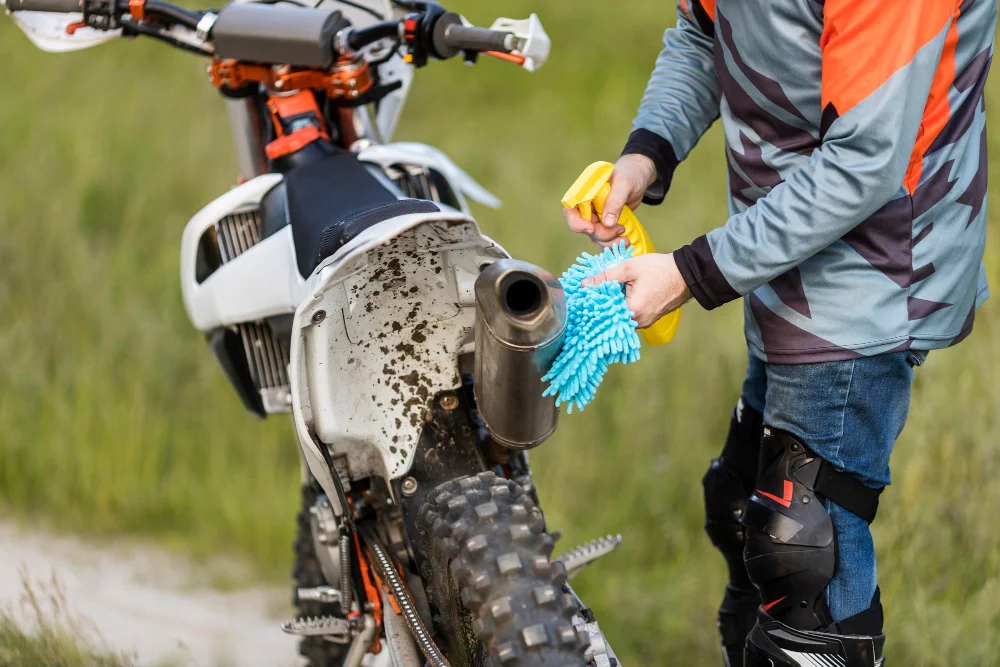 close-up-man-cleaning-dirt-bike